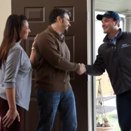 carrier hvac tech shaking hands with homeowner