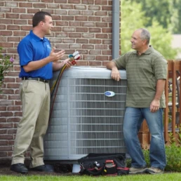 tech performing hvac maintenance while talking to homeowner